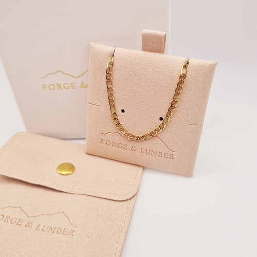18K gold plated chain bracelet from Forge and Lumber, waterproof and tarnish-free, displayed in a soft pouch.