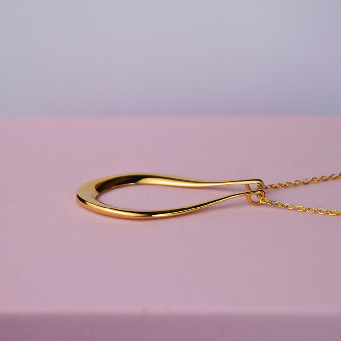 The Abalone ring holder necklace in gold, teardrop pendant on a fine chain