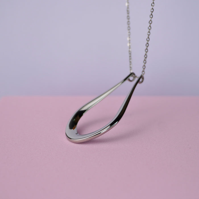 The Abalone silver teardrop ring holder pendant, shown close up
