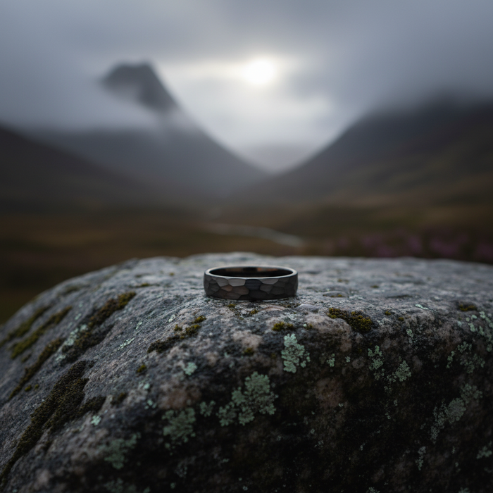 The Anvil 6mm ring on mossy stone with misty mountains behind