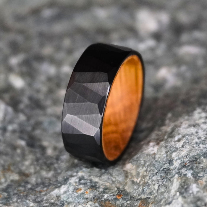 Black tungsten wedding band with 8mm faceted design and wooden interior by Forge and Lumber.