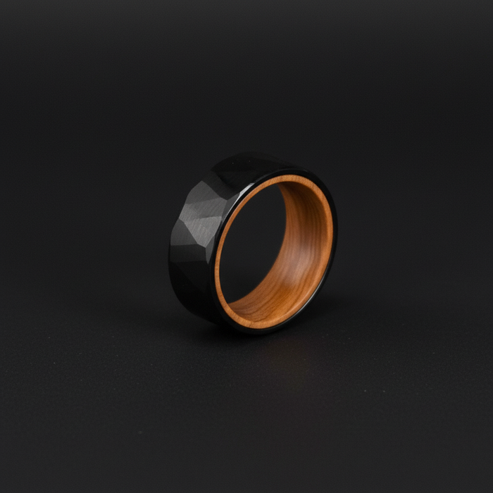 Sleek black faceted ring with a wooden interior, showcasing a modern design in "The Barrelhouse."