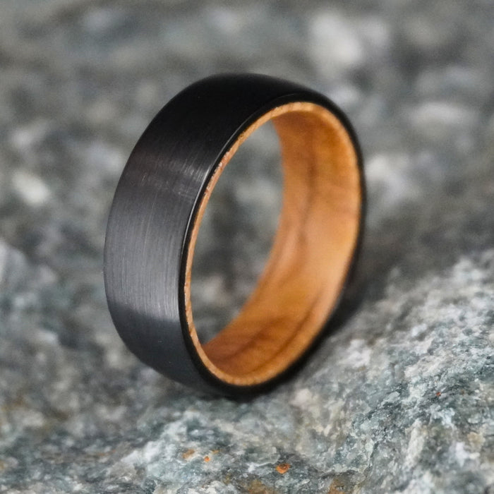The Campbell 8mm black tungsten band with a barrel oak interior