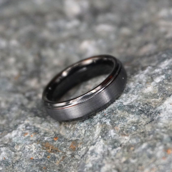 The Cannon 6mm bevelled tungsten band in a matte gunmetal finish