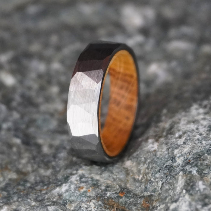 Durable barrel-inspired ring with a faceted metal exterior and wooden interior by Forge and Lumber.