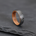 The Damascus 6mm, a Damascus steel band with a whisky barrel oak interior