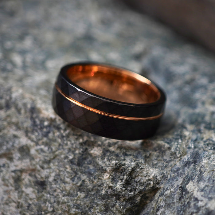 Black comfort-fit wedding band with a durable design and rose gold inlay by Forge and Lumber.