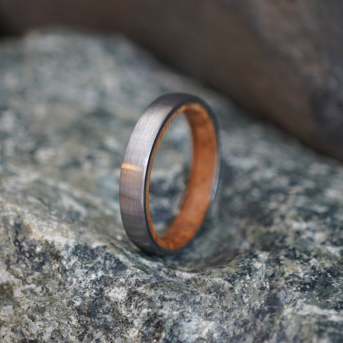 The Glen 4mm tungsten band with a barrel oak interior