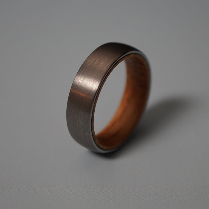 The Glen 6mm, a round-profile tungsten band with a whisky barrel oak interior