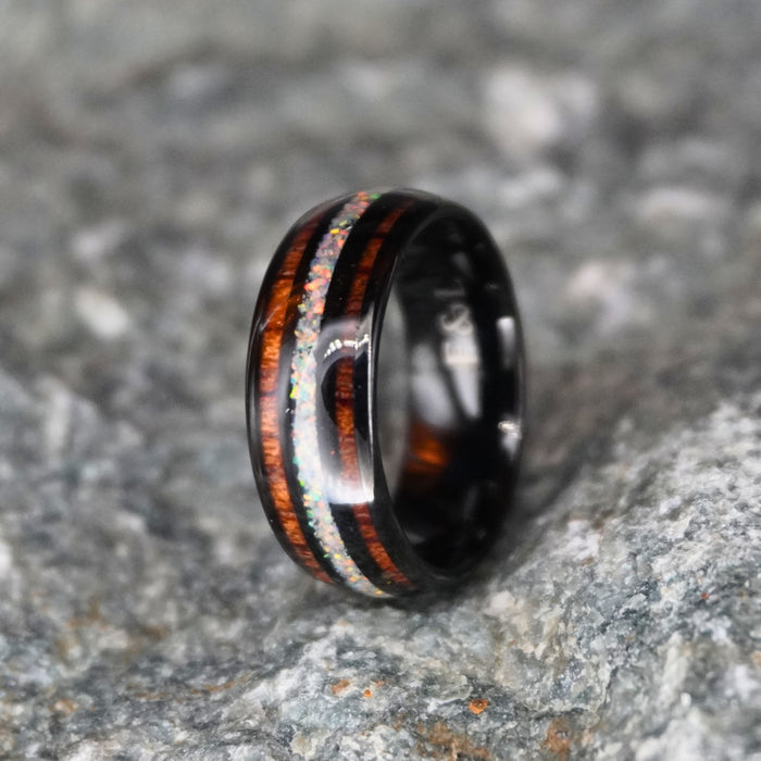 The Opallios 8mm black tungsten ring with opal and Koa wood