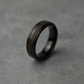The Peat, a 6mm bevelled black plated tungsten band with a Koa wood inlay