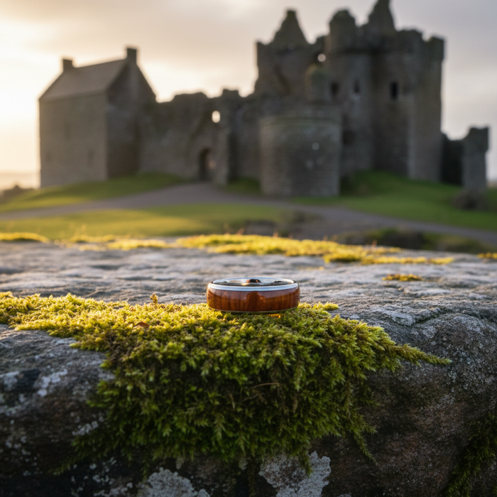 The Royal 8mm ring on mossy stone at castle ruins