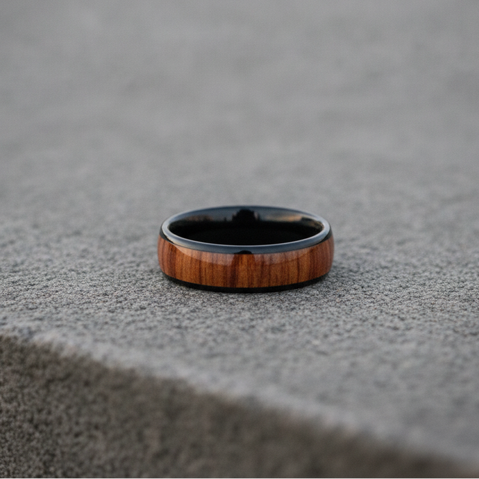 The Ukulele, an 8mm round-profile black plated tungsten band with a Koa wood inlay