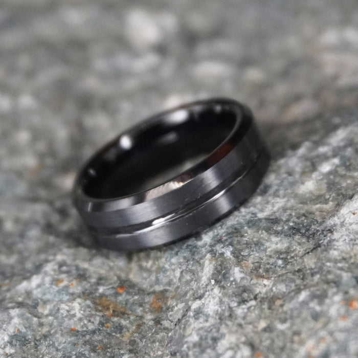 The Waka 8mm bevelled black tungsten band shown at an angle