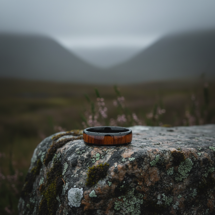 The Warrior 6mm ring on a mossy rock in a misty landscape
